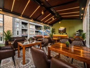 a restaurant with tables and chairs in a room at The Moksh DA Hotel A Premium Property Near Jaypee Hotel in Mussoorie