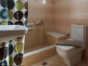 a bathroom with a toilet and a shower and a sink at Rose Garden in Melíkia