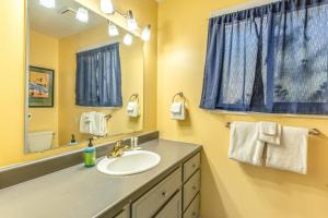 a bathroom with a sink and a mirror at Cozy Escape in Bigfork +54 photos