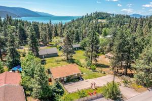 an aerial view of a house with trees and a lake at Cozy Escape in Bigfork