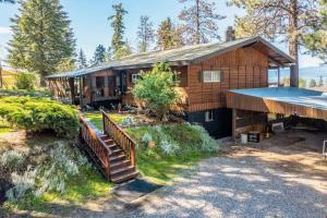 a house with a staircase leading up to it at Hilltop Hideaway in Bigfork