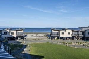 a view of the beach from the balcony of a house at Saratoga Beach Villa 4 in Oyster Bay