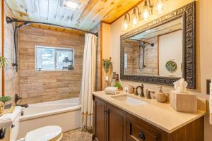 a bathroom with a sink and a tub and a toilet at Hilltop Hideaway in Bigfork +78 photos