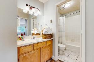 a bathroom with a sink and a toilet and a tub at Big Horn 3 in Big Sky +43 photos