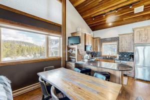 a kitchen with a table and a large window at Big Horn 18 in Big Sky