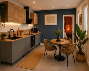 a kitchen with a table and chairs and a sink at Le Refuge de Chateau Renard in Château-Renard +7 photos