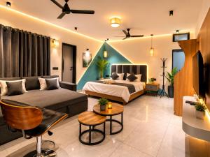 a living room with a bed and a couch at Peach stay in Mount Ābu