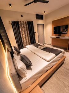 a large bed in a room with a television at Peach stay in Mount Ābu +27 photos
