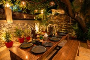 a wooden table with plates on top of it at Peach stay in Mount Ābu