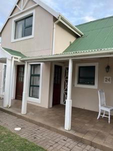 a house with a chair on a patio at River & Salt at Stilbaai in Stilbaai-Oos