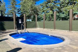 a small blue pool with a fence and trees at Snowcreek 791 in Mammoth Lakes