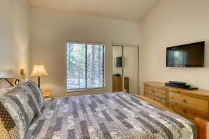 a bedroom with a large bed and a television at The Summit 276 in Mammoth Lakes +104 photos