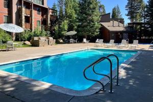 a swimming pool with a metal rail in a resort at The Summit 276 in Mammoth Lakes
