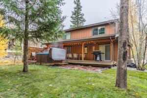 a house with a screened in porch and a tv at 7th Fairway Getaway in Columbia Falls
