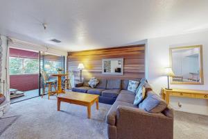 a living room with a couch and a table at The Bridges 102 in Mammoth Lakes