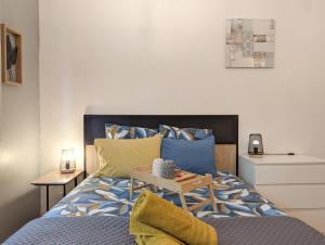 a bedroom with a bed with a table on it at L'Aiglon Studio cocon au coeur de Gap in Gap
