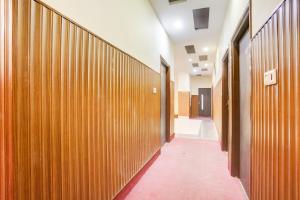 a hallway with wooden panels in a building at Townhouse by OYO Brahma Sarovar Formerly Krishna mahal in Kurukshetra +30 photos