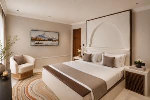 a hotel room with a bed and a chair at YAMA Villa Udaipur in Udaipur +38 photos