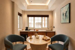 a kitchen with a table and two chairs at YAMA Villa Udaipur in Udaipur