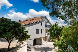 a white house with a red roof at Desamani 975 in Kostrena