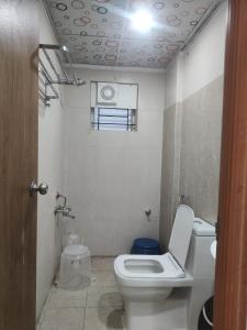 a small bathroom with a toilet and a window at Sri Sai Comforts Manyata Tech Park in Bangalore +18 photos