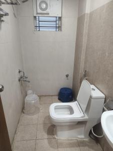 a bathroom with a toilet and a sink at Sri Sai Comforts Manyata Tech Park in Bangalore