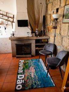a living room with two chairs and a rug at One Bedroom House in Povoa Dao in Povoa Dao