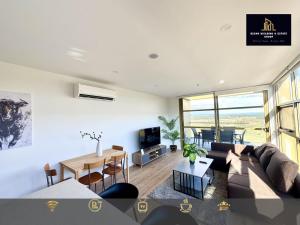 a living room with a couch and a table at C04-Summerfield Stylish 2BR Apart, Mountain view in Weston Creek