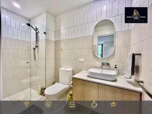 a bathroom with a toilet and a sink and a shower at C04-Summerfield Stylish 2BR Apart, Mountain view in Weston Creek +19 photos