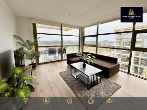 a living room with a couch and a table at C04-Summerfield Stylish 2BR Apart, Mountain view in Weston Creek
