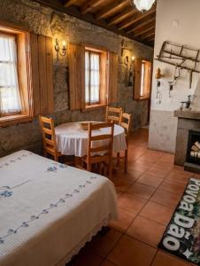 a room with a table and chairs and a kitchen at One Bedroom House in Povoa Dao in Povoa Dao