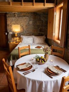 a white table with a bowl of fruit on it at One Bedroom House in Povoa Dao in Povoa Dao
