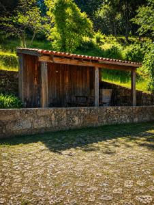 a wooden structure sitting on top of a stone wall at One Bedroom House in Povoa Dao in Povoa Dao +15 photos