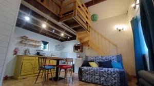 a living room with a couch and a table at Le chalet des paons - Le Mond'idéal in Felon