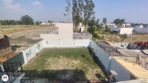 an aerial view of a building with a yard at hotel Neelgiri in Kichha