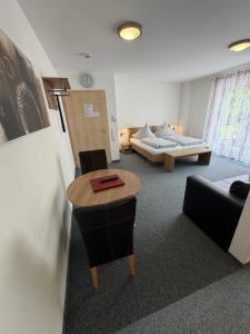 a room with a table and chairs and a couch at Apartments Am Grafenberg in Grafenberg
