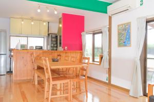 a kitchen with a wooden table and chairs at UMICHIKA AOSHIMA - Private house 一棟貸し in Miyazaki