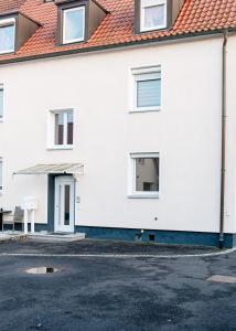 a white house with a red roof at Casa Materi Schweinfurt in Schweinfurt