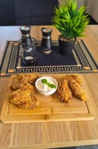 a wooden table with a plate of food on a table at NOVA Motel in Międzyrzecz