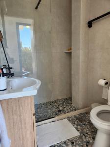 a bathroom with a sink and a toilet at Big apartment on the beach in Tolo +36 photos