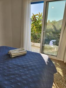 a bedroom with a bed with two towels on it at Big apartment on the beach in Tolo
