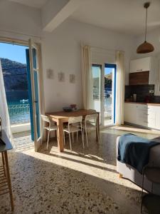 a dining room with a table and a view of the ocean at Big apartment on the beach in Tolo