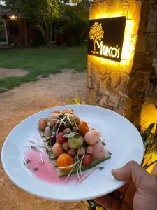 a person holding a plate of food on a table at Shannu's Ranch Inn in Pushkar +20 photos