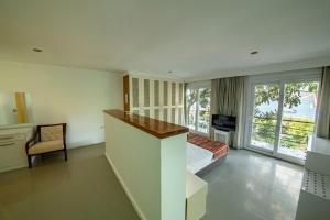 a bedroom with a bed and a desk and a television at La Moda Beach Hotel in Kaş +25 photos
