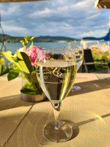 a glass of wine sitting on a table at Lakesideview Keutschach am See in Keutschach am See