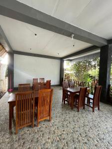 a dining room with wooden tables and chairs at Fetung Bayan Homestay in Senaru