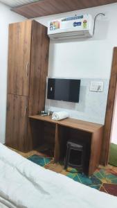 a desk with a computer on it in a room at Mark inn hotel in Hanumāngarh +17 photos