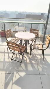 a table and chairs on a balcony with a view at Mark inn hotel in Hanumāngarh