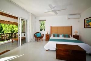a bedroom with a bed and a balcony at Villa Eva in Belle Mare +75 photos