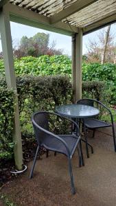 two tables and chairs sitting under a gazebo at Amblers Rest Accomodation in Drury